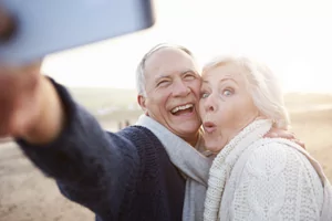 Happy denture implants couple smiling for the camera