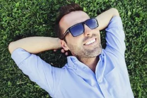 Man relaxing with nice smile from restorative dentistry in Toms River