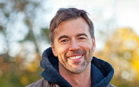 Smiling man shows off his TeethXpress full mouth dental implant dentures in Toms River, NJ.