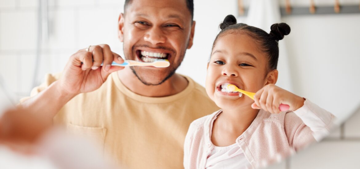 father and daughter brushing their teeth in Toms River