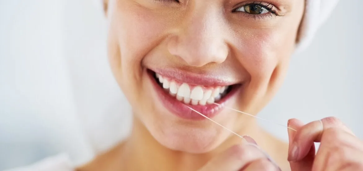 young woman smiling confidently, showing her perfect white smile