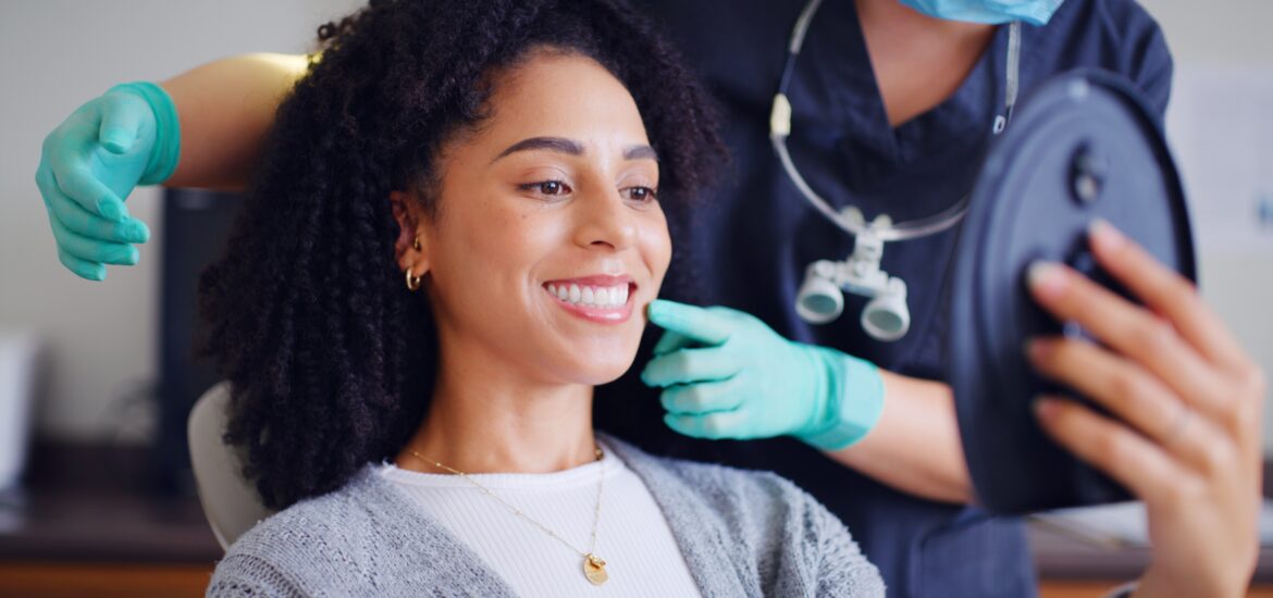 young woman smiling in a dental chair, routine dental cleaning