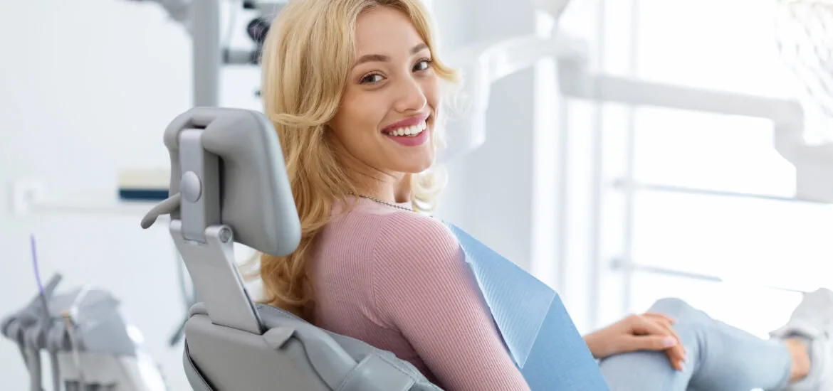 young woman smiling calmly in a modern dental office