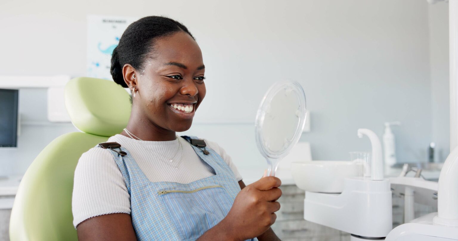 happy woman in a dental chair, newly whitened teeth